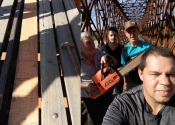 Voluntários trocam tábuas na ponte
